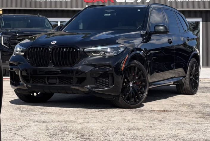 Black BMW X5 M50i at the dealership